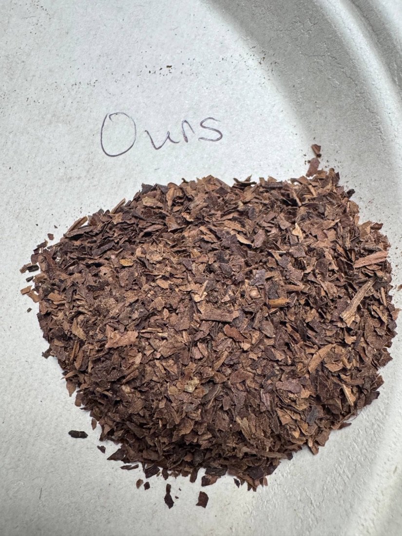 Close-up of chopped Kill Moe tobacco leaf on a plate labeled Ours